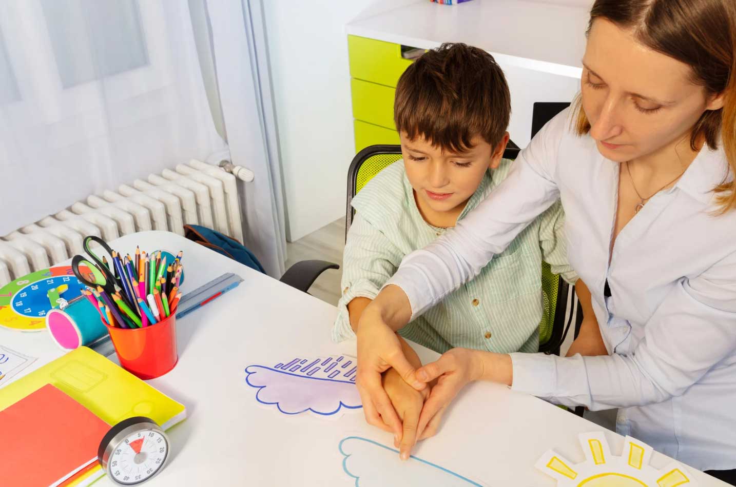 A boy and therapist using Visual Supports during ABA therapy.